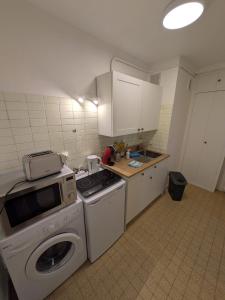 a kitchen with a stove and a washing machine at Le petit casino in Menton