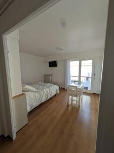 a bedroom with a bed and a table and a television at Le petit casino in Menton