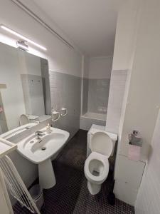 a bathroom with a white toilet and a sink at Le petit casino in Menton