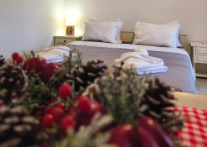 a bedroom with a bed with christmas decorations on it at Creta Irini's Rooms3 in Tympáki