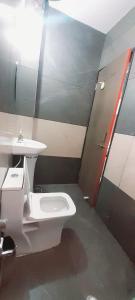 a bathroom with a sink and a toilet at HOTEL RAJBHOG indore in Indore