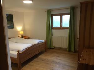 a small bedroom with a bed and a window at Ferienwohnung Thöny in Vandans