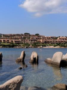 a body of water with rocks in the water at Appartamenti Baia Smeralda in Santa Marinella