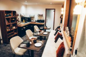 a living room with a couch and tables and chairs at Chalet Nest in Les Saisies