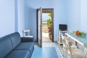 a blue living room with a couch and a table at Appartamenti Baia Smeralda in Santa Marinella