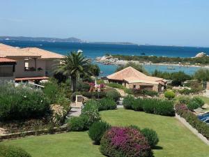 a garden with flowers and plants in front of a house at Appartamenti Baia Smeralda in Santa Marinella