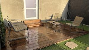a patio with chairs and a table and a window at Suite Moon & Spa in Amnéville