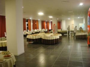 a banquet hall with tables with food on them at Santa Loja Hotel Residence in Tito