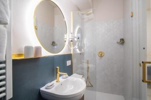 a bathroom with a sink and a mirror at Piazza Duomo Guest House in Ariano Irpino +30 photos