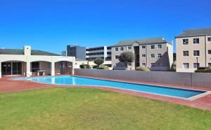 a swimming pool in front of a building at Stanley's Place at 212 Salerno in Cape Town