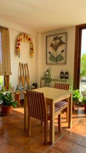 a dining room with a wooden table and chairs at Mar de viñas in San Asensio +12 photos