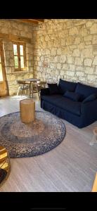 a living room with a blue couch and a table at ELINN traditional suits in Kathikas