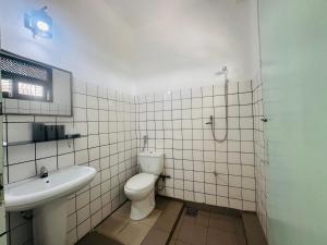a bathroom with a toilet and a sink at Nice Days Resort Unawatuna in Unawatuna