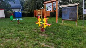 a group of childrens playground equipment in the grass at Lubuskie jezioro in Wilkowo