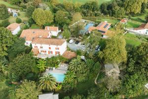 an aerial view of a house with a swimming pool at Maison Irriberria in Hasparren