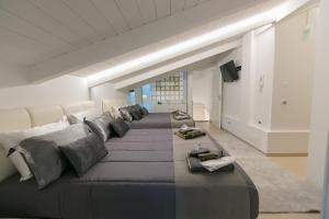 a large bed with many pillows in a room at ALMAR HOLIDAY - Crotone in Crotone