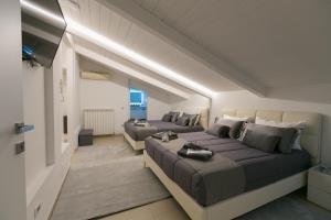 a bedroom with a large bed and a couch at ALMAR HOLIDAY - Crotone in Crotone