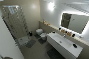 a white bathroom with a sink and a shower at ALMAR HOLIDAY - Crotone in Crotone +33 photos
