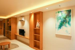 a living room with a painting on the wall at AN Studio VVT in Ho Chi Minh City