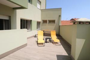 a patio with chairs and a table on a building at DaKing in Vila do Conde
