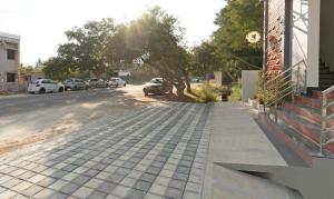 a sidewalk next to a street with parked cars at Treebo Global Orchid in Mysore +21 photos
