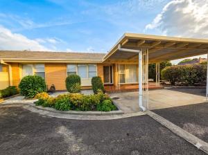 a house with a covered parking lot in front of it at The Hamlyn Haven - Sleeps 5 - Central Location in Hamlyn Heights