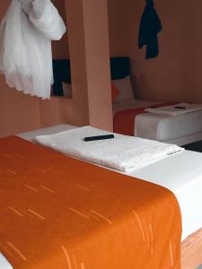a bedroom with two beds with white sheets at Wonderful Guesthouse in Kimana