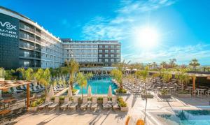 a resort with a pool and chairs and a building at Vox Maris Resort - Ultra All Inclusive in Side +86 photos