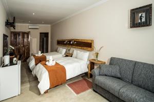 En eller flere senge i et værelse på Casa Forno Country Hotel