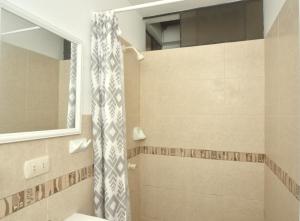 Un baño con cortina de ducha y lavabo. en Casa mar surfhouse, en Punta Hermosa 40 fotos más