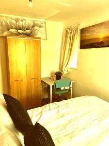 a bedroom with a bed and a desk and a table at High class accommodation in Bury