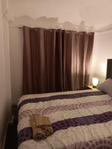 a bedroom with a bed and a window with curtains at High class accommodation in Bury