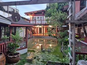 een huis met een koivijver in de tuin bij Casa Scarlet in Bangkok