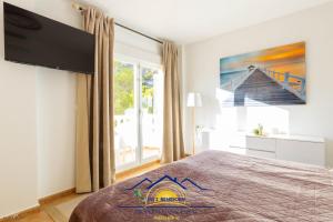 a bedroom with a bed and a large window at Altea Hillside Harmony in Altea