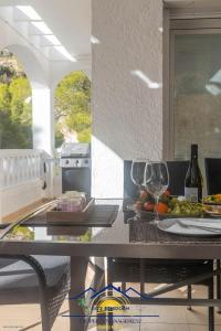 a table with wine glasses and food on it at Altea Hillside Harmony in Altea