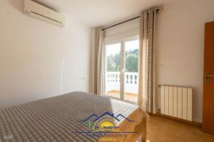 a bedroom with a bed and a large window at Altea Hillside Harmony in Altea +45 photos