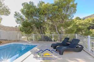 a patio with two chairs and a swimming pool at Altea Hillside Harmony in Altea