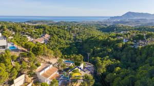 an aerial view of a town with trees and the ocean at Altea Hillside Harmony in Altea