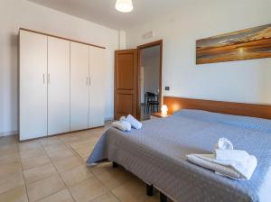 a bedroom with a bed with towels on it at Premium apartment in Villasimius in Villasimius