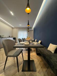 a dining room with a table and a couch at Telese Charme B&B in Telese