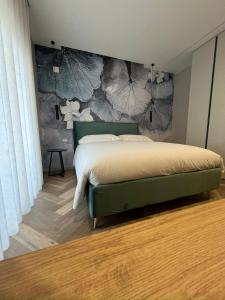 a bedroom with a bed and a wall with flowers at Telese Charme B&B in Telese +12 photos