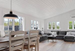 a living room with a couch and a table at Beach House Near Sejerø Bay in Hønsinge