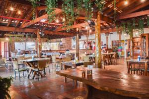 a restaurant with tables and chairs in a room at O Sole Mio - Hotel Pousada in Planura
