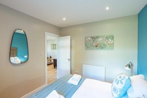 a bedroom with a bed and a mirror at Birch Lodge 15 in Newton Stewart