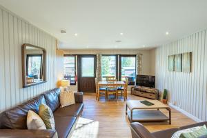 a living room with a couch and a table at Birch Lodge 15 in Newton Stewart