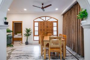 a dining room with a wooden table and chairs at Anji Retreat in Dharampur