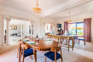 ein Esszimmer und ein Wohnzimmer mit Tisch und Stühlen in der Unterkunft Estoril Royal Atlantic Villa with Ocean View in Estoril