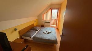 a small room with a bed and a window at 2 room apartment, Hriadky, Liptovsky Mikulas in Liptovský Mikuláš