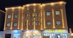 a large building with lights on it at night at رفاه in Medina