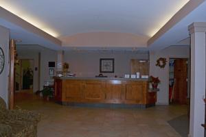 a large lobby with a reception desk in a building at Paola Inn and Suites in Paola